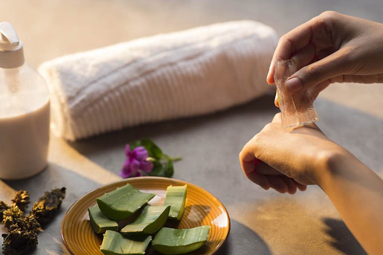 massage towels, aloe Vera plant on floor and a female hand hold her finger